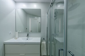 Shower, hair dryer, towels, toilet paper