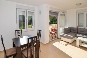 Apartment, 1 Bedroom, Balcony | Living area | Flat-screen TV