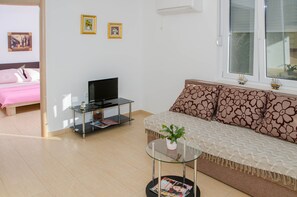 Standard Apartment, 1 Bedroom, Balcony | Living area | Flat-screen TV