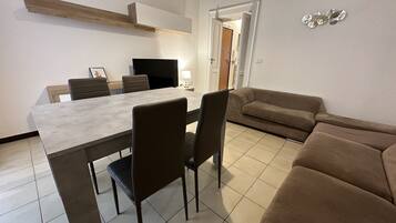 Deluxe Apartment | Living area | 50-inch flat-screen TV with digital channels, TV