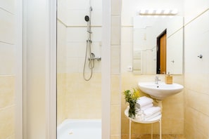 A bathroom with a shower, a sink, and a mirror. - Modern APT in Center by Michal&Friends (Prague)