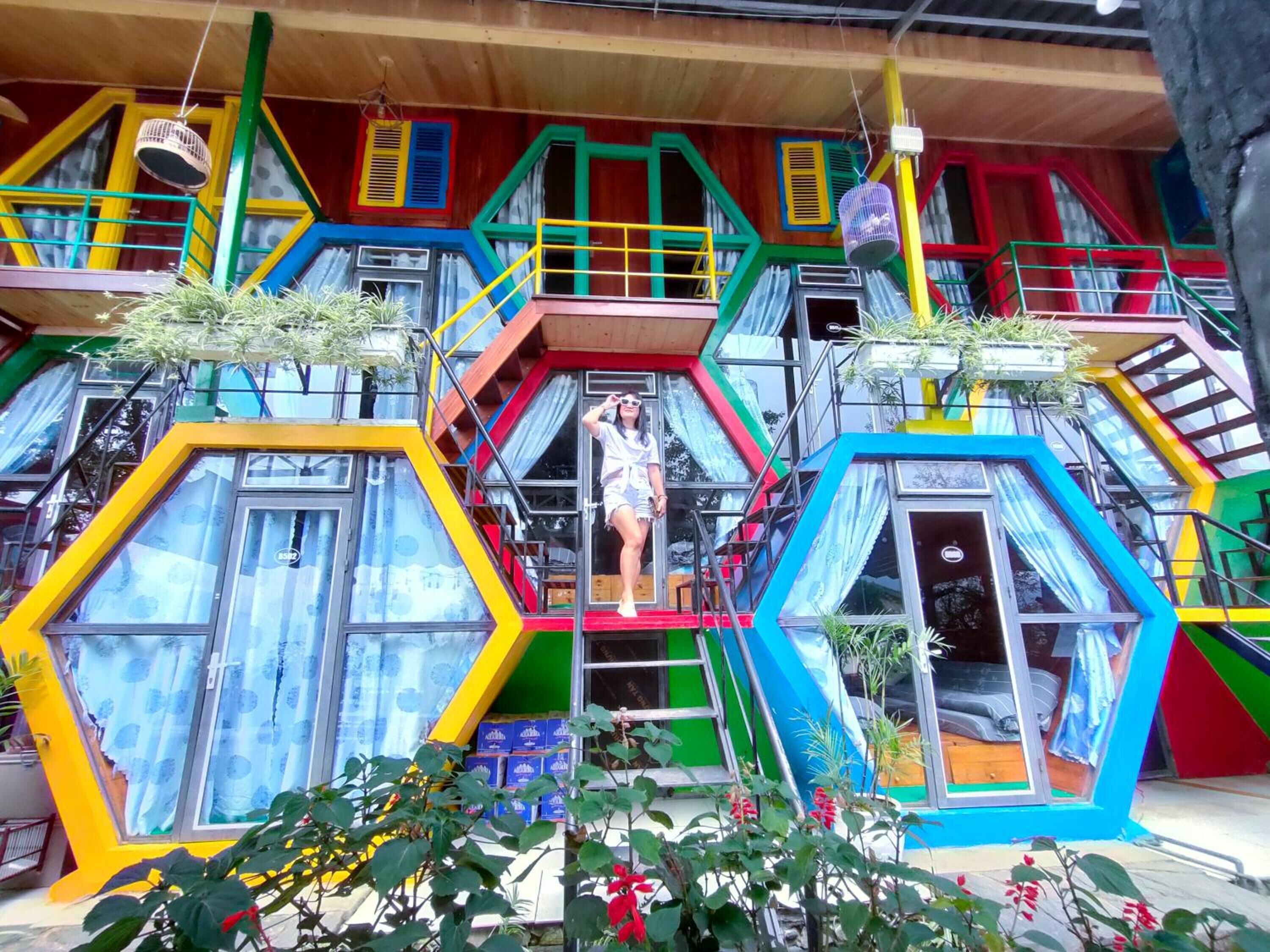 A colorful, multi-level building with hexagonal windows and balconies.