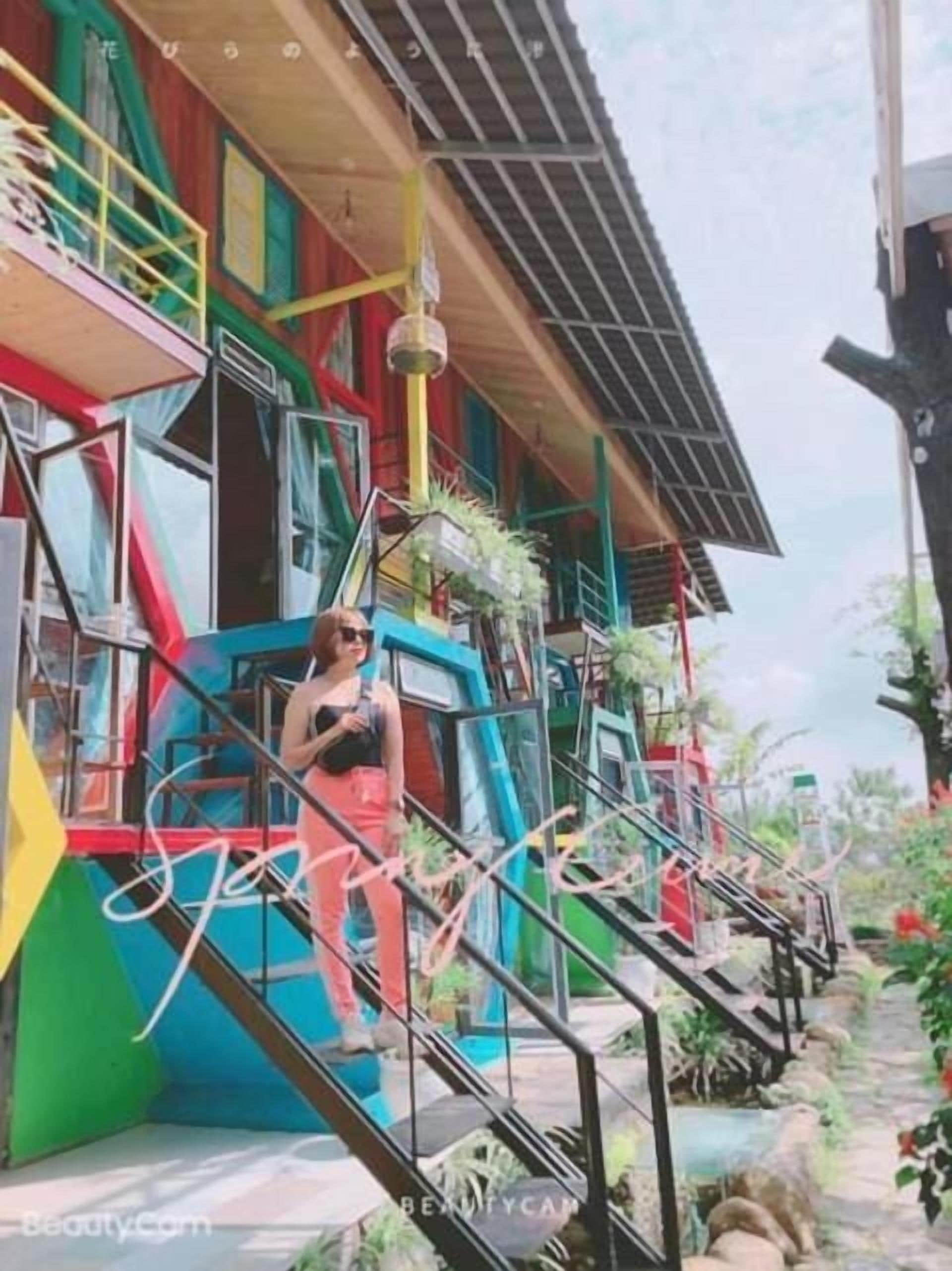 A colorful building with a staircase leading to a balcony.
