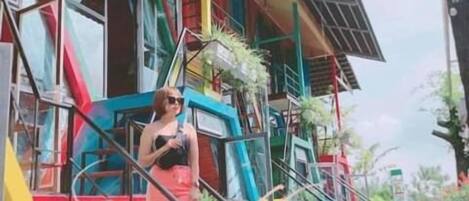 A colorful building with a staircase leading to a balcony.