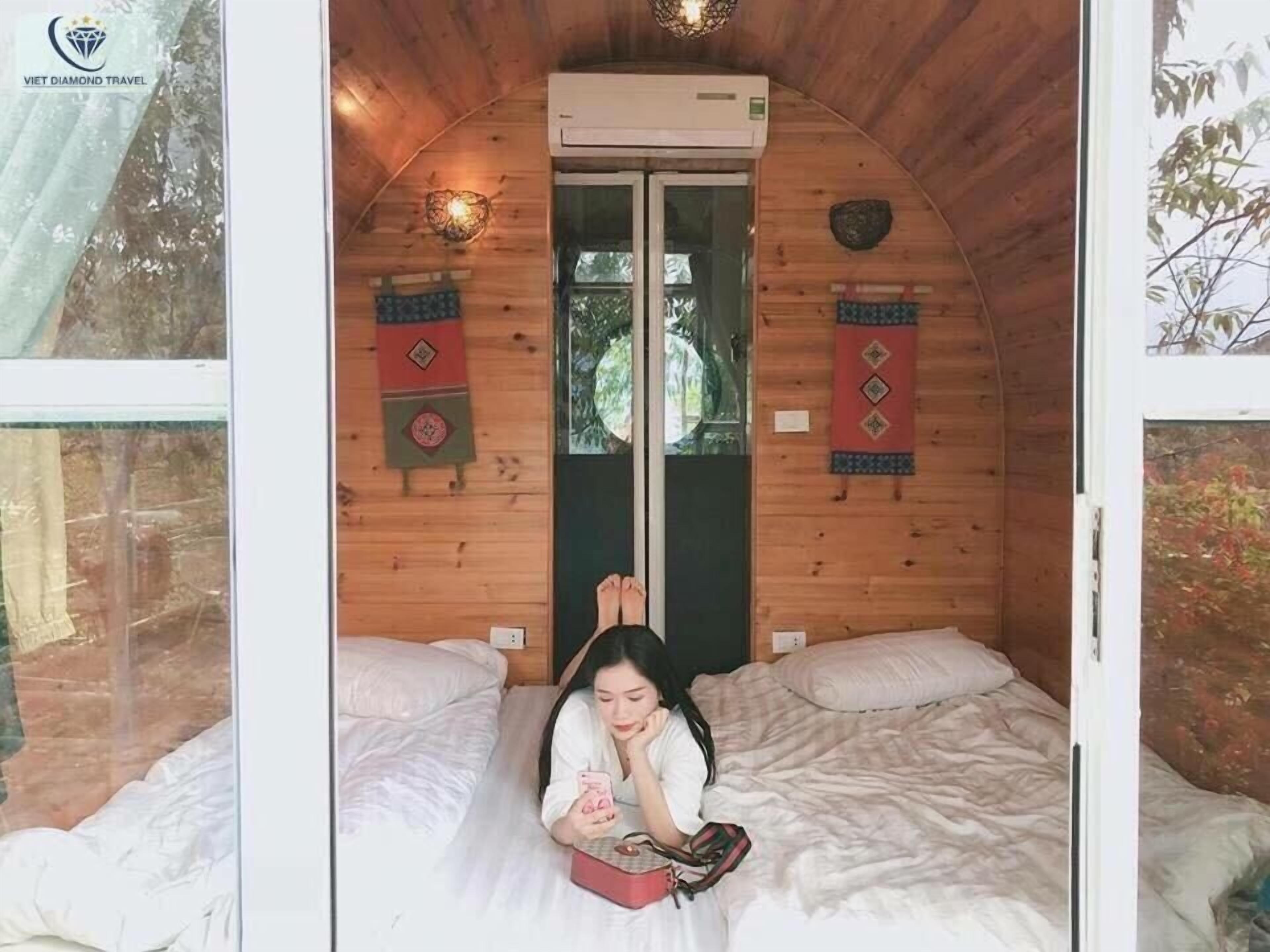 A cozy cabin with a bed, a window, and an air conditioning unit.