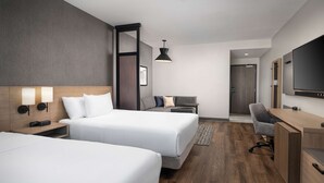A hotel room with two beds, a desk, a TV, and a bathroom door. - Hyatt Place Amarillo-West (Amarillo)
