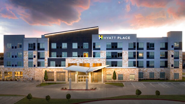 A multi-story hotel with a modern design, featuring a prominent entrance and a parking lot. - Hyatt Place Amarillo-West (Amarillo)