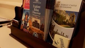 A brochure holder with various travel guides, including one for Blenheim Palace and another for Sudeley Castle & Gardens. - The Portland Guesthouse (Cheltenham)