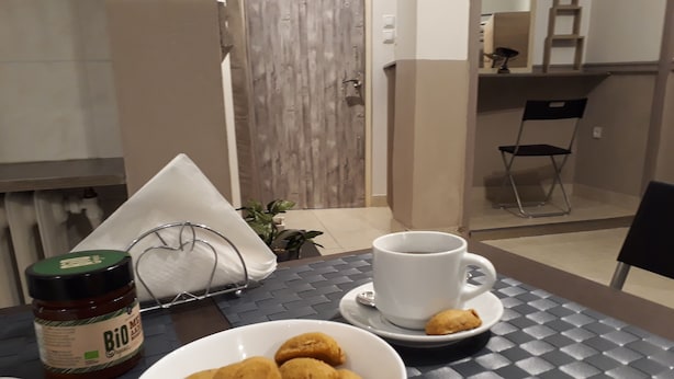 A dining table with a bowl of food, a cup of coffee, and a jar of spread. - Central Cozy Cute Downtown Studio 1BR (Athens)