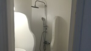 A bathroom with a shower, toilet, and a sink. - Gorgeous Mykonian Studio DT Ornos (Mykonos)