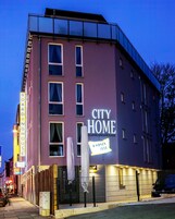Un edificio con un letrero que dice "CITY HOME BOARDINGHOUSE".