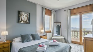 A hotel room with a bed, a nightstand, a bedside table, a mirror, and a view of the outdoors. - Alcam Can Macia (Corbera De Llobregat)