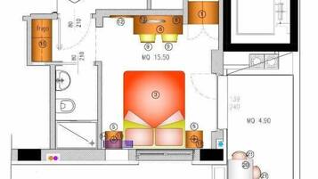 Plano de planta que muestra una cocina, comedor y dos dormitorios.