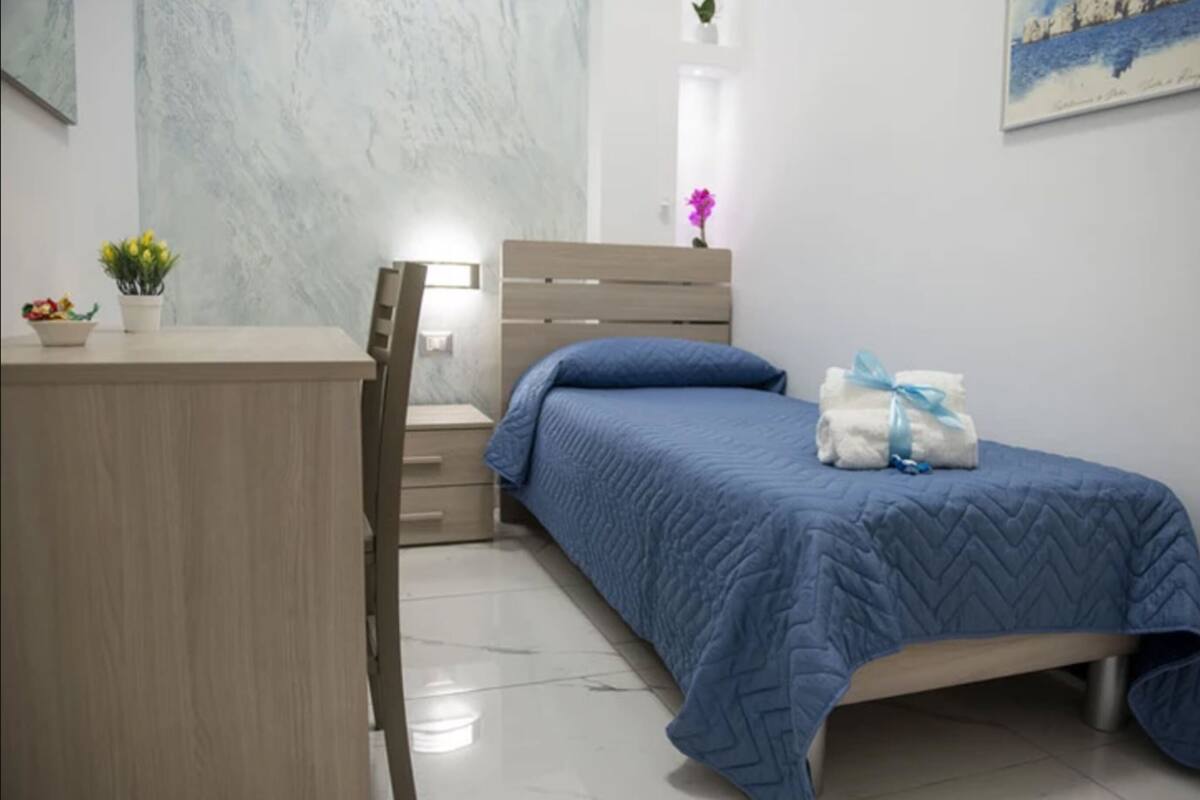 Une chambre à coucher avec un lit, un bureau et une chaise.