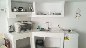 A compact kitchen with a built-in oven, a sink, and a dishwasher. - Classy Mykonian Studio - Ornos (Mykonos)