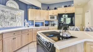 A modern kitchen with wooden cabinets, a stainless steel refrigerator, a built-in oven, and a large window. - 10 Min TO DT, 16 min to Biltmore, Lg Home,  Apartment Incl., Peaceful & Quiet (Asheville)