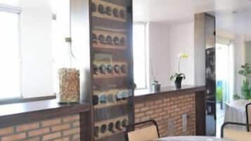 A dining area with a brick wall, a round table, and chairs.