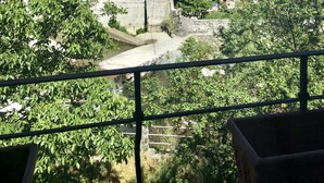 A historic town with a prominent church featuring a bell tower, a bridge, and a river. - La casa sul fiume (Ellera)