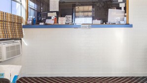 A restaurant counter with a menu, a 'No Smoking' sign, and a 'Thank You For Not Smoking' sign. - OYO Hotel Brookhaven MS Hwy 51 North (Brookhaven)