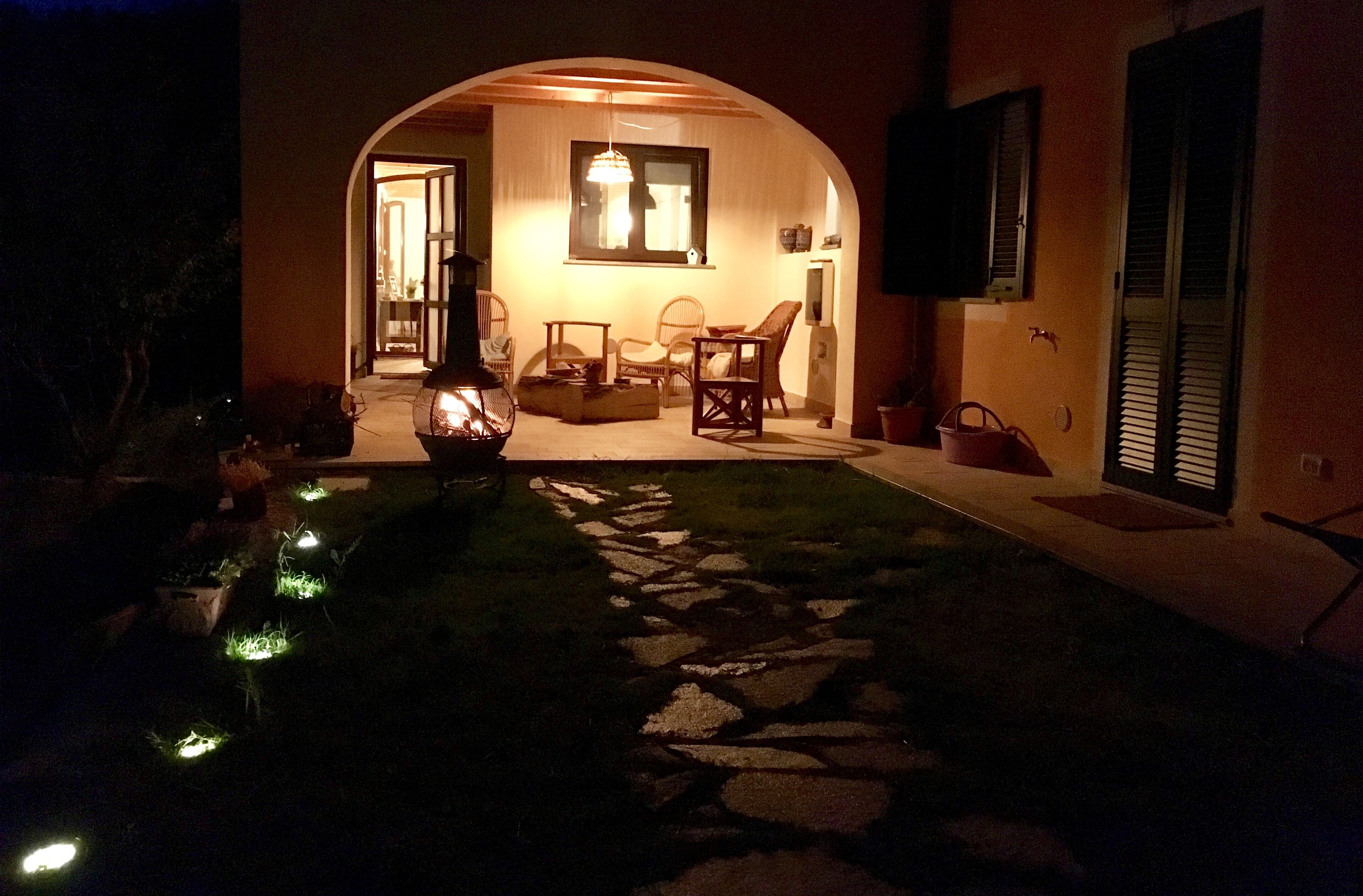 A cozy indoor seating area with a stone pathway leading to a door.