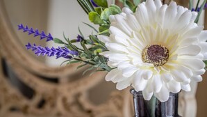 A white flower in a dark glass vase. - Altahammond House (Carrickfergus)
