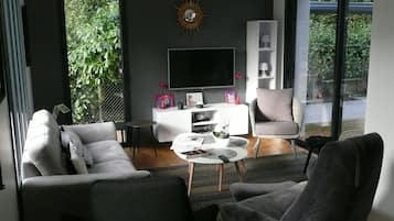 Télévision, cheminée, table de tennis de table, livres