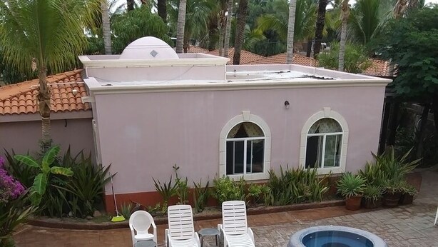 A swimming pool with lounge chairs and a hot tub, surrounded by potted plants and palm trees. - Casita El Sol, Pool View. (Loreto)