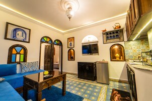 Deluxe Apartment | Living area | Flat-screen TV