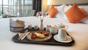 A neatly arranged breakfast tray with eggs, bacon, and toast on a hotel bed. - Best Western Premier Westlands (Nairobi)