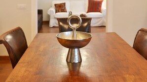 A dining area with a wooden table, a metal bowl, and a chandelier. - Casa Mozart Hotel Boutique (Las Palmas de Gran Canaria)