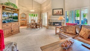 A spacious living room with a fireplace, a dining area, and a cozy seating area. - Santa Rosa Cove #16 - Greenbelt, 3 bedroom/3.5 bath, permit 063424 (La Quinta)