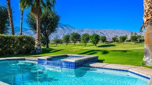 A swimming pool with a view of a mountain range and a well-maintained lawn. - PGA West #11 - 3 bedroom Pool Home -Weiskopf, LQ permit #111254 (La Quinta)