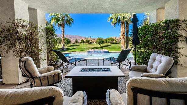 A patio area with a pool, outdoor seating, and a view of a golf course. - PGA West #11 - 3 bedroom Pool Home -Weiskopf, LQ permit #111254 (La Quinta)
