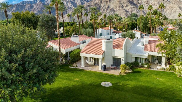A residential area with white houses, red-tiled roofs, and palm trees. - Santa Rosa Cove #42, 3 BD /3.5 BA, Pet Friendly Home, Permit 063486 (La Quinta)