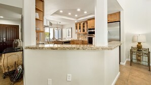 A modern kitchen with granite countertops, wooden cabinets, and stainless steel appliances. - Santa Rosa Cove #42, 3 BD /3.5 BA, Pet Friendly Home, Permit 063486 (La Quinta)