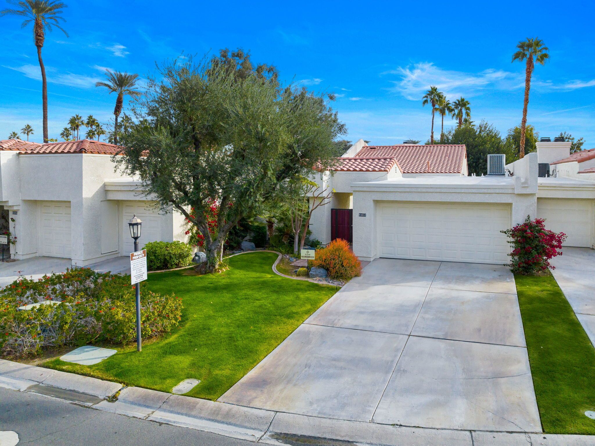 A residential property with a well-maintained lawn, a driveway, and a garage.
