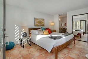A modern bedroom with a large bed, a bedside table, a lamp, and a wall-mounted artwork. - Santa Rosa Cove #50, 3 Bedrooms   3.5 Baths  La Quinta City Permit 063498 (La Quinta)