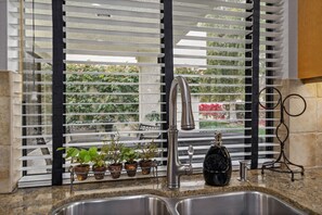 A kitchen with a stainless steel sink, a faucet, and a window with blinds. - Santa Rosa Cove #57, 3 bedroom/2bath, Permit 063491 (La Quinta)