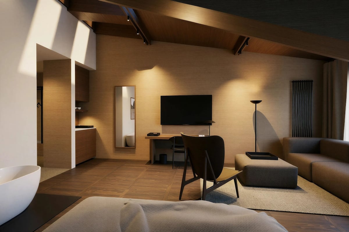 A modern living room with a flat-screen TV, a sofa, a chair, and a dining area.