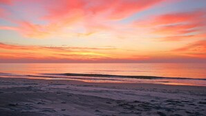 A beach with a sunset. - Lovely 1st floor villa less than 100 yards to the beach/oceanfront pool. (Hilton Head Island)