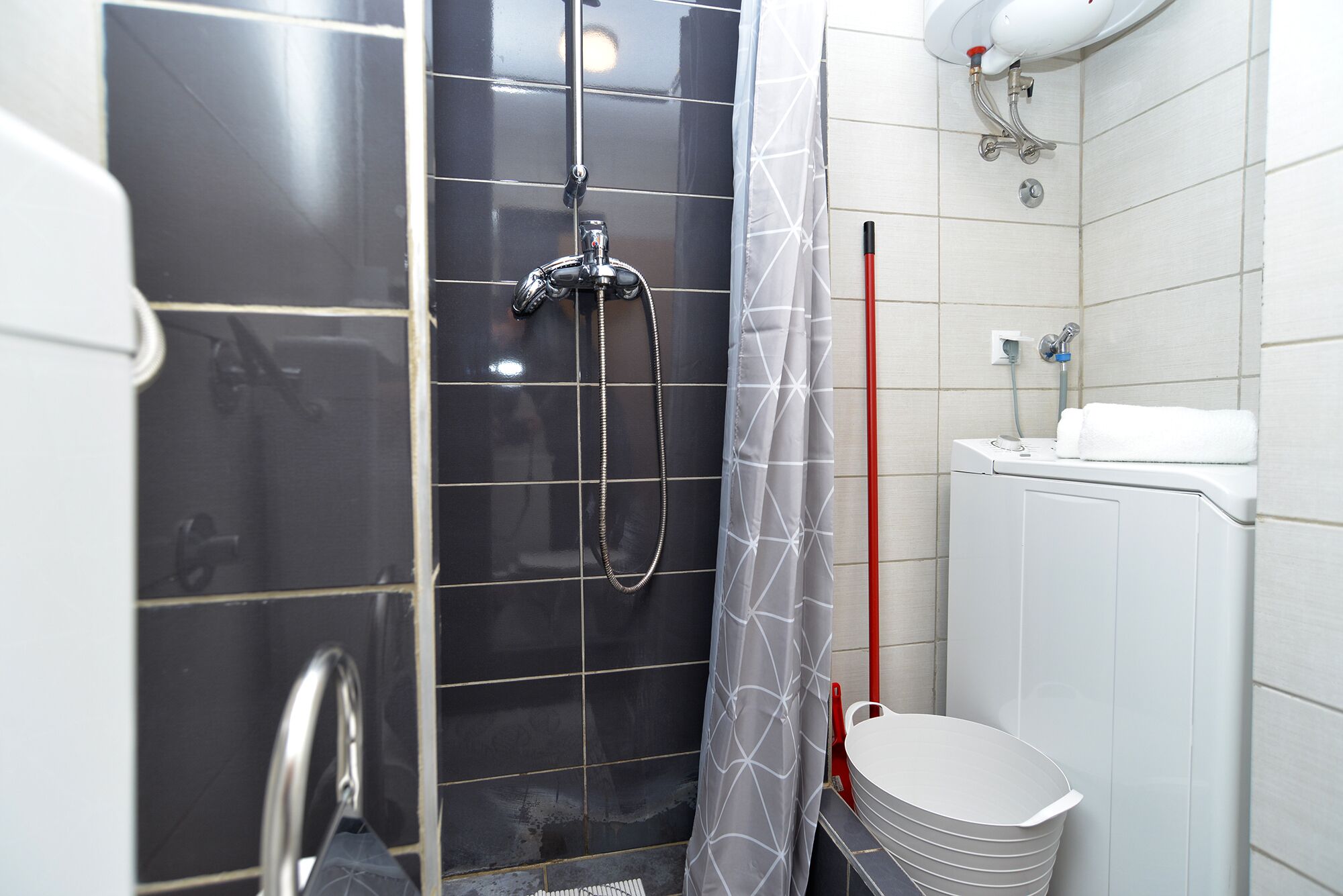 A bathroom with a shower, toilet, and sink.