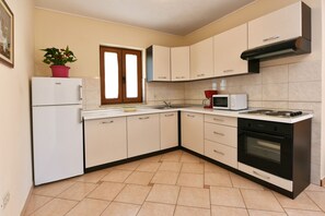 Enjoy cooking in this well-equipped kitchen with a refrigerator, microwave, stove, and oven.