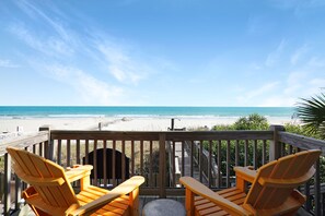 A wooden deck with two orange Adirondack chairs facing a beach. - Retreat w/ Private Pool & Ocean Views, 4BR, Pet-Friendly (Surfside Beach)