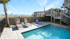 A pool area with a wooden deck, two lounge chairs, and a wooden staircase leading to a deck. - Retreat w/ Private Pool & Ocean Views, 4BR, Pet-Friendly (Surfside Beach)