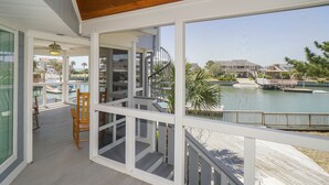 A covered outdoor area with a view of a pool and buildings. - Inlet Front 5BR Home w/ Private Dock & Walk to Beach (Garden City Beach)