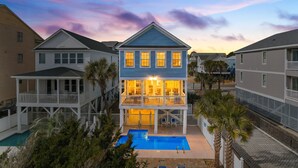 A two-story house with a balcony, a swimming pool, and a view of neighboring houses. - 5BR House with Private Pool Near Surfside Pier (Surfside Beach)