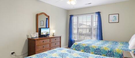Drift off in comfort with two plush beds, coastal decor, and gentle ceiling fan breezes to keep you cool.