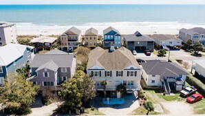 A coastal residential area with houses, a beach, and a clear view of the ocean. - 5BR Ocean-Side Home w/ Private Pool & Ocean Views Near Surfside Pier (Surfside Beach)