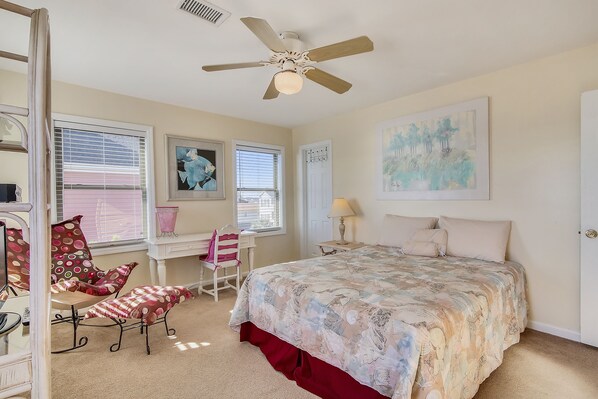 A bedroom with a bed, a desk, a chair, and a ceiling fan. - 5BR Cottage w/ Private Deck & Stunning Sunrises (Garden City Beach)