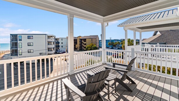 A covered outdoor area with a view of the beach and buildings. - Walk to Beach 6BR Home w/ Private Pool & Ocean Views (Garden City Beach)